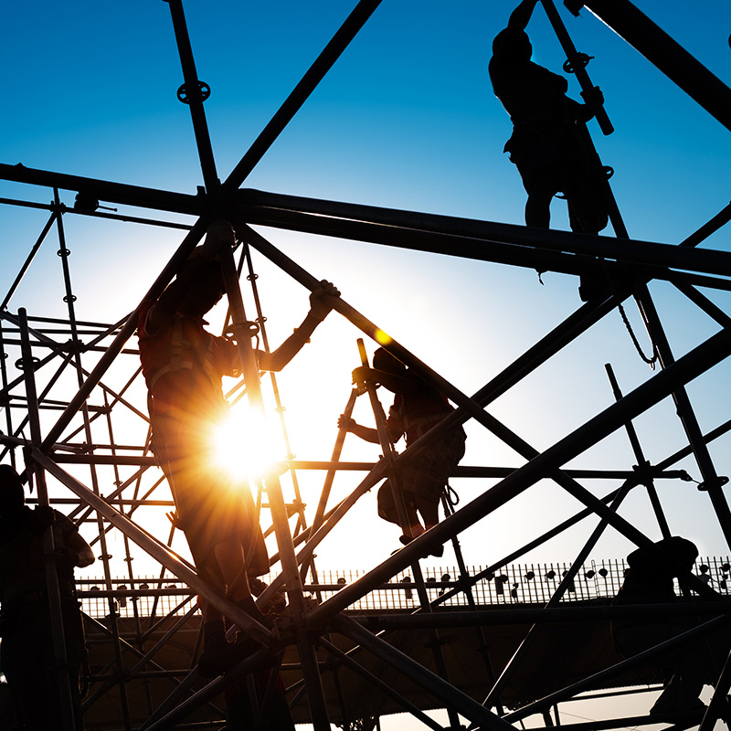 Group of construction workers working on scaffolding