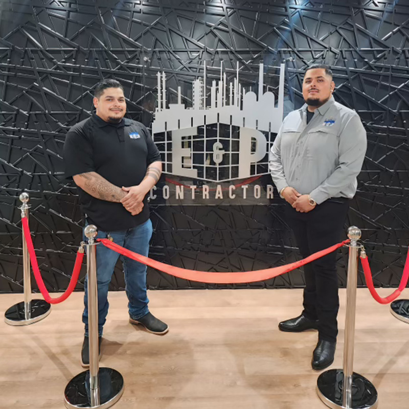 Workers in front of sign