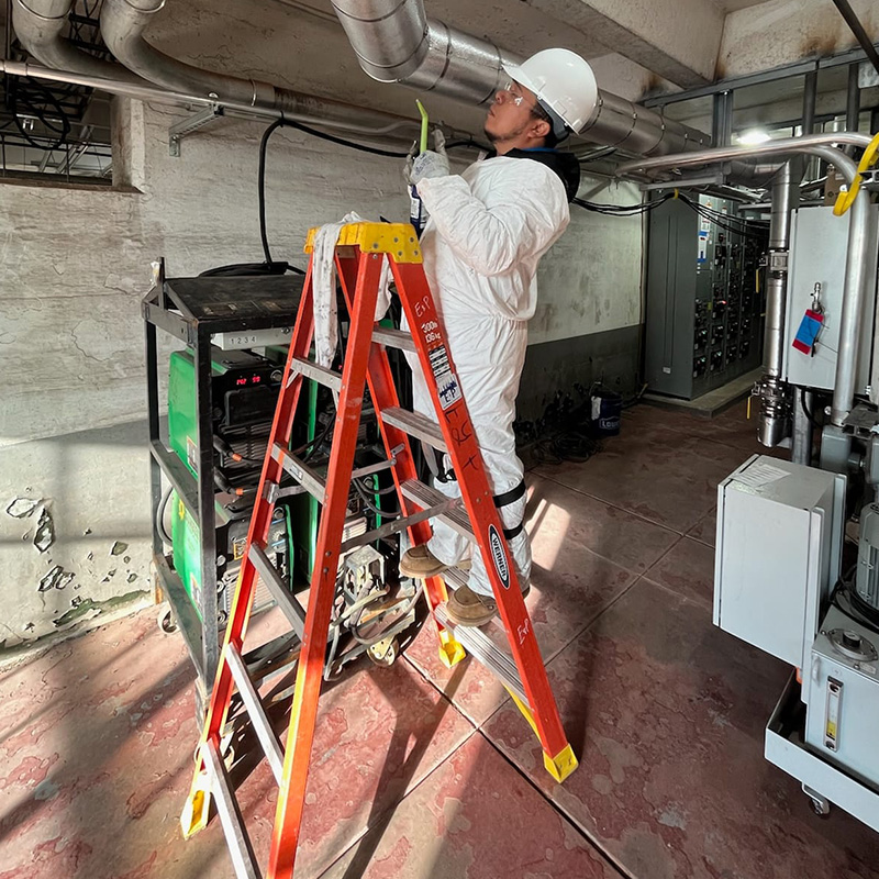 Worker inspecting Ducts
